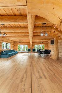 a large room with wooden ceilings and a table and chairs at Dor De Munte in Mărişel