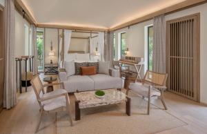 a living room with a couch and a bedroom at JW Marriott Ranthambore Resort & Spa in Sawāi Mādhopur
