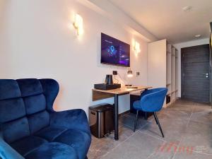 a room with a desk and a couch and a computer at A Plus Hotel St Julians - Adults Only in St. Julianʼs