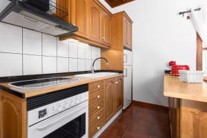 a kitchen with a sink and a stove at Home2Book La Molina B, Cozy Country House in Triquivijate