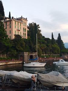 two boats are docked in the water in front of a building at Appartamento nonna Piera in Casargo