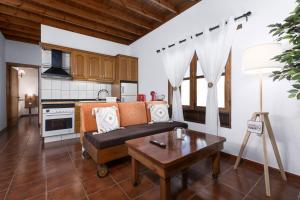 a living room with a couch and a table at Home2Book La Molina B, Cozy Country House in Triquivijate