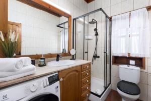 a bathroom with a sink and a washing machine at Home2Book La Molina B, Cozy Country House in Triquivijate +16 photos