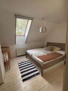 a bedroom with a bed and a window at Gallery loft Myjava Hrachoviste in Hrachovište