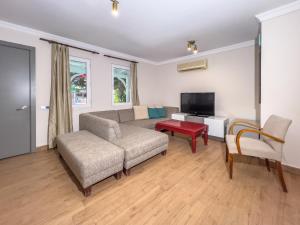 a living room with a couch and a tv at Moonshine Hotel Suites in Bodrum City