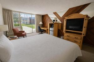 a hotel room with a bed and a television at Motel 6 Rawlins, WY in Rawlins