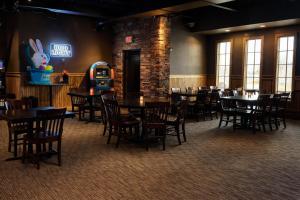 a dining room with tables and chairs and a room with a restaurant sign at Motel 6 Rawlins, WY in Rawlins