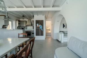 a kitchen and living room with a table and chairs at Villa Tonic by Mykonos Mood in Agios Ioannis Mykonos