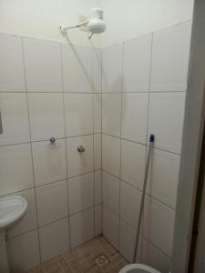 a bathroom with a shower with a toilet and a sink at Hotel e Galeria Vizza in Goiânia