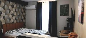 a small bedroom with a bed and a window at Studio Type Furnished Condo in Lapu Lapu City +8 photos
