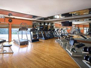a gym with several treadmills and elliptical machines at Novotel Bangkok Bangna in Bangna +33 photos