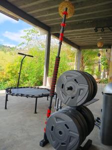 a gym equipment with a wheel and a table at Villa Sol hospedaria in Paty do Alferes