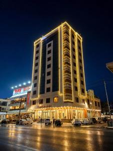 a large building with lights on top of it at MyFlower 1 Hotel in Erbil