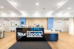 an office with a yerspace sign on a desk at YourSpace Hotels Chesapeake in Chesapeake
