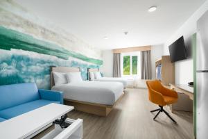 a hotel room with a bed and a desk at YourSpace Hotels Chesapeake in Chesapeake +53 photos