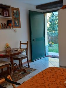 a room with a table and a sliding glass door at Villa Bella Liguria B&B in Favale di Malvaro