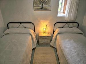 a bedroom with two beds and a lamp on a night stand at Inés in Tijarafe