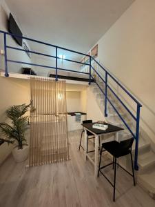 a dining room with a table and a staircase at HomeSuite22 in Diamante