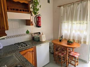 a small kitchen with a table and a counter top at Inés in Tijarafe