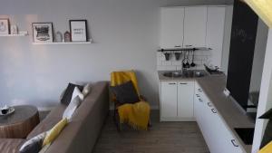 a living room with a couch and a kitchen at Widokówka in Tarnobrzeg