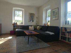 a living room with a blue couch and a table at Forsthaus Castell in Castell