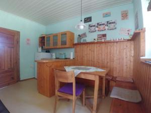 a kitchen with wooden cabinets and a table and chairs at Forsthaus Castell in Castell