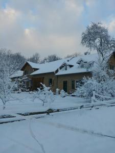 a house with snow on the roof of it at Forsthaus Castell in Castell