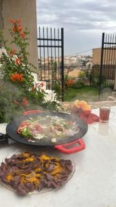 two plates of food are sitting on a table at شاليه إطلالة in Buraydah