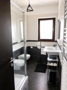 a bathroom with a toilet and a sink and a shower at Casa Ulivo in Pulsano +17 photos