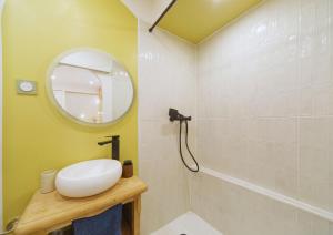 a bathroom with a sink and a mirror at Studio Welcome, petit espace, grand confort in Arudy +7 photos