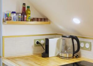 a kitchen counter with a blender on top of it at Studio Welcome, petit espace, grand confort in Arudy