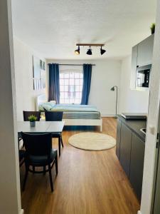 a room with a bed and a table and chairs at Apartment Altstadt Stralsund in Stralsund