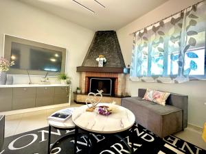 a living room with a couch and a fireplace at Theros Lux Apartment in Émbonas