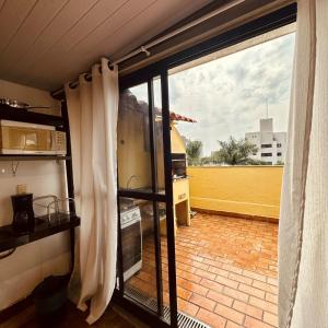 a view of a kitchen from the window of a house at Cobertura Mangabeiras com vista incrível de BH e área gourmet in Belo Horizonte