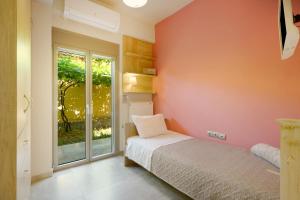 a bedroom with a bed and a large window at Peaceful house in Goúrnes +24 photos