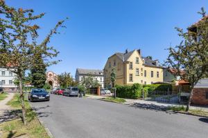 a street with cars parked on the side of the road at Altstadt Quartier in Bad Freienwalde