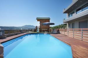 a swimming pool on a deck with a house at Peaceful house in Goúrnes