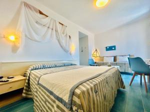 a bedroom with a bed and a table and a chair at Hotel Sant'Andrea in Marciana +114 photos