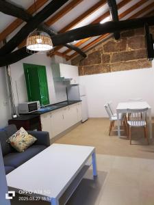 a living room with a couch and a table at Muiño Verde in Loña del Monte