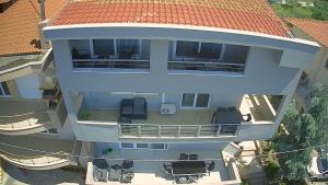 an aerial view of a house with a red roof at Villa Joanna Seasides , Top Floor in Mesimérion +70 photos