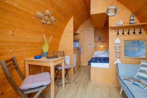 a cabin with a table and chairs in a room at Hausboot Captain Hook in Stralsund +25 photos
