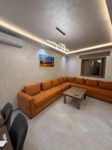 a living room with a couch and a table at اقامة هبة 2 in Yebha
