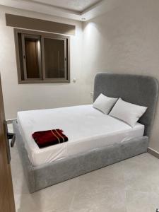 a bedroom with a large bed with white sheets at اقامة هبة 2 in Yebha