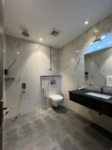a bathroom with a sink and a toilet and a tub at Brick House Hotel Lahore in Lahore +130 photos