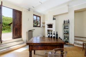 a room with a table with bottles of wine at Ciabot delle Aie - Barolo in Barolo +80 photos