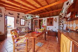 a kitchen and living room with a wooden table at Casitas Manuel in El Paso