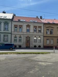 a building with a blue van parked in front of it at StayCentralcz- Loft in Opava