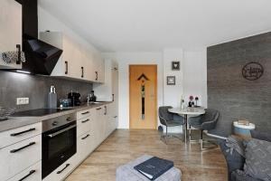 a kitchen and living room with a table and chairs at Ferienwohnung Griesbaum in Tengen +20 photos