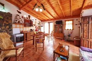 a kitchen with wooden ceilings and a table and chairs at Casitas Manuel in El Paso
