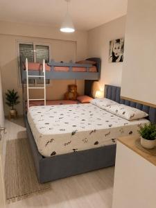 a bedroom with two bunk beds in a room at Sirel Home in Durrës